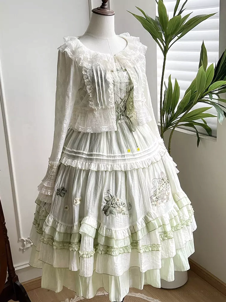 White ruffled lolita cardigan paired with green embroidered tiered skirt on dress form full-length lolita coordinate styling