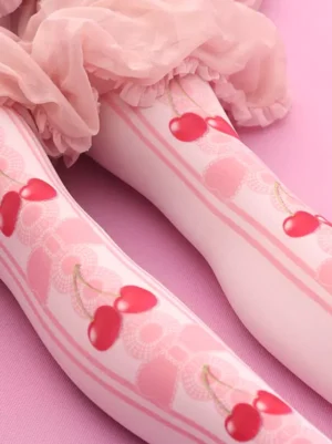 Lolita knee-high cherry printed stockings side close-up detail showing pink lace bow patterns soft fabric texture and red cherry designs against pink background