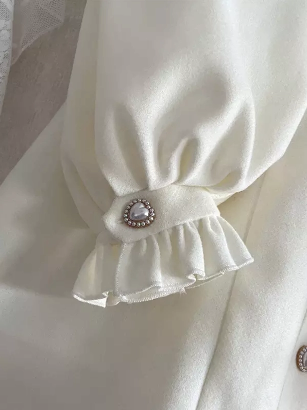 Lolita coat bishop cuff close-up flat view showing ruffled cuff detail, pearl decorative button, and matte fabric texture