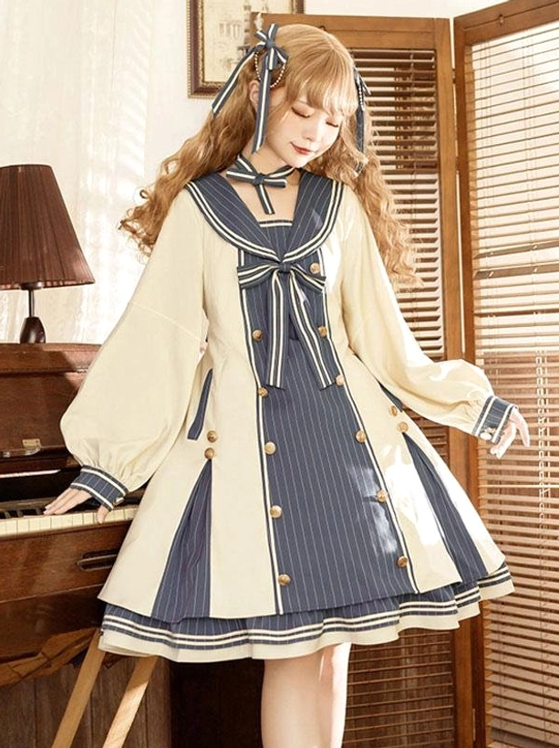 Side front view of A-line sailor lolita dress showing navy striped panel details, layered silhouette, cream and navy two-tone coloring, and refined proportions on model with decorative head bow