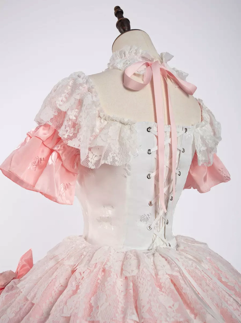 Pink sweet lolita dress bow placement and structure detail showing statement front bows and chest embellishments