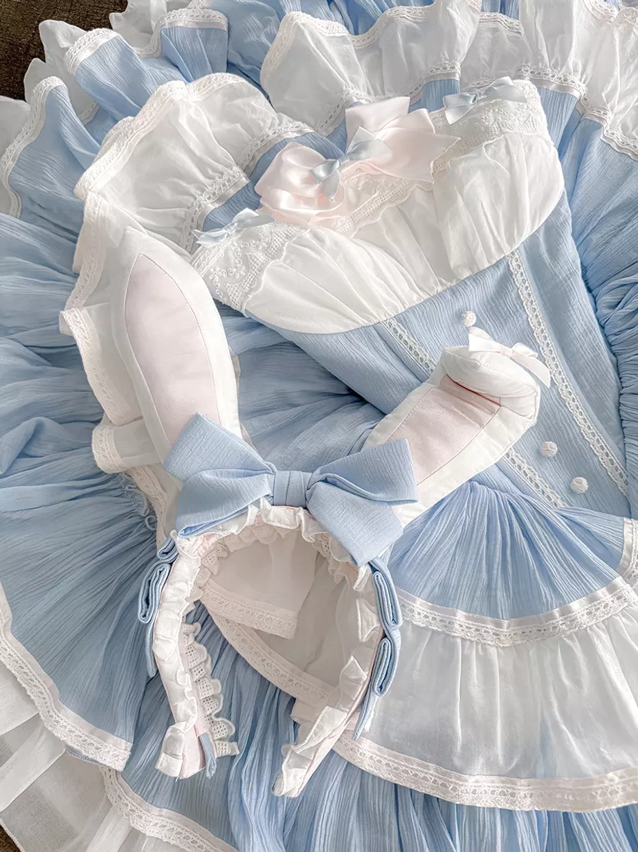 Close-up detail of lolita dress bodice showing bunny ear bow centerpiece, pleated fabric construction, and sky blue white color scheme with precision ruffling
