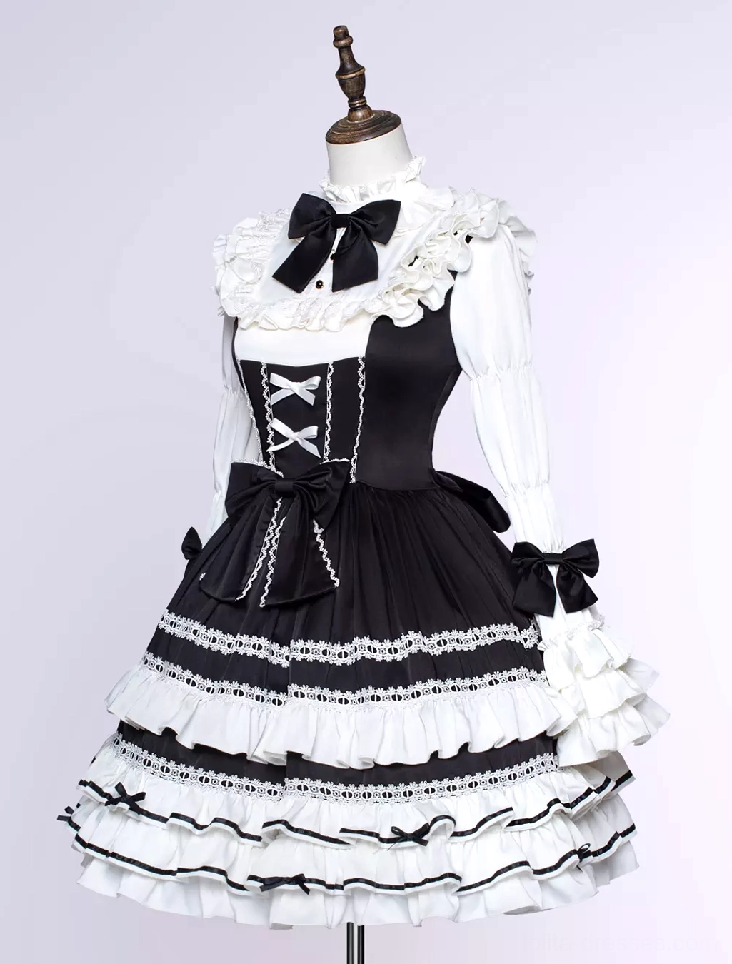 Classic black gothic lolita dress detail shot highlighting multi-layer ruffle construction, lace trim embellishment, and high-quality fabric texture