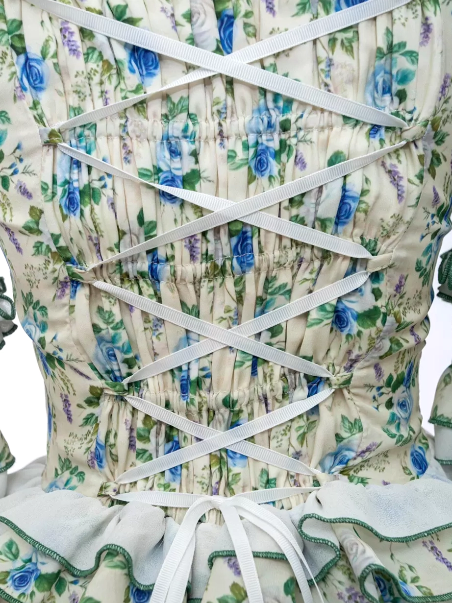 Lolita dress full silhouette tiered ruffles volume structure emerald green ribbon bows floral print front view