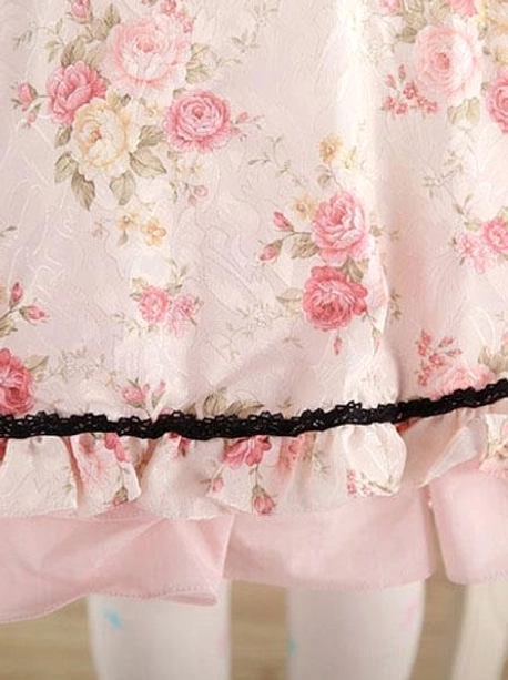 Lolita dress hem detail close-up showing double-layered ruffled design, black ruffled lace trim contrast, pink base fabric, floral printed skirt layer, ruffles texture