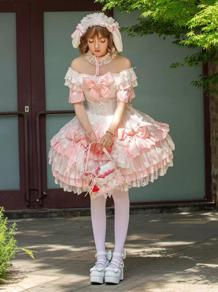 Sweet lolita dress with lace flower basket holding model and bunny ear hair accessory outdoor glass door location