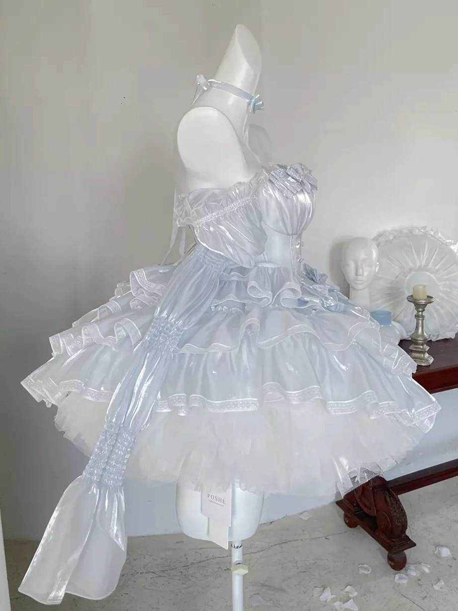 Sweet lolita dress with long detachable left sash front three-quarter view, light blue bow choker, layered ruffle skirt, and coordinating accessories