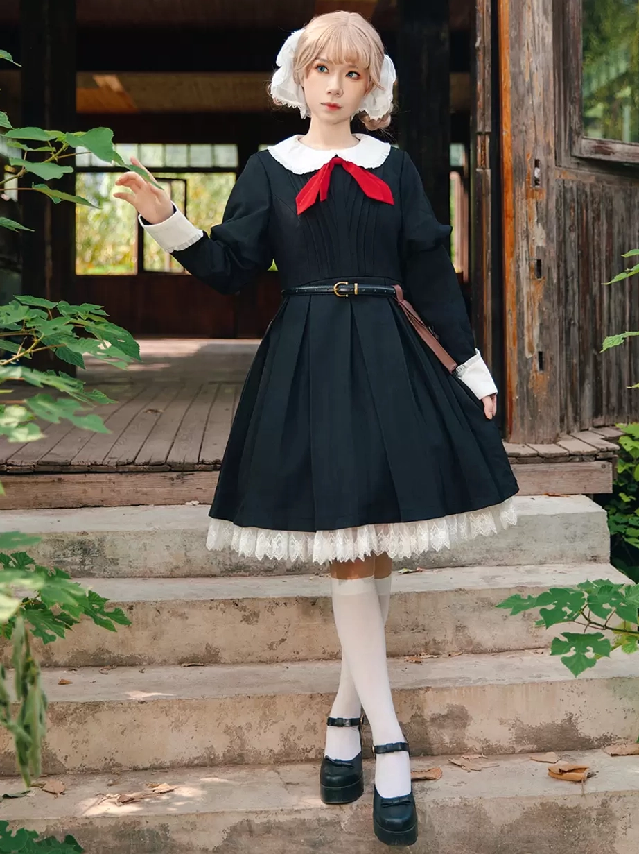 Right three-quarter view of model wearing classic lolita dress on outdoor stairs, posing with raised hand, showing waist belt and complete coordinated silhouette