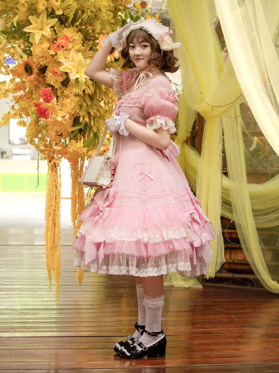 Lolita dress right side three-quarter view featuring square neckline layered lace skirt and crossbody bag