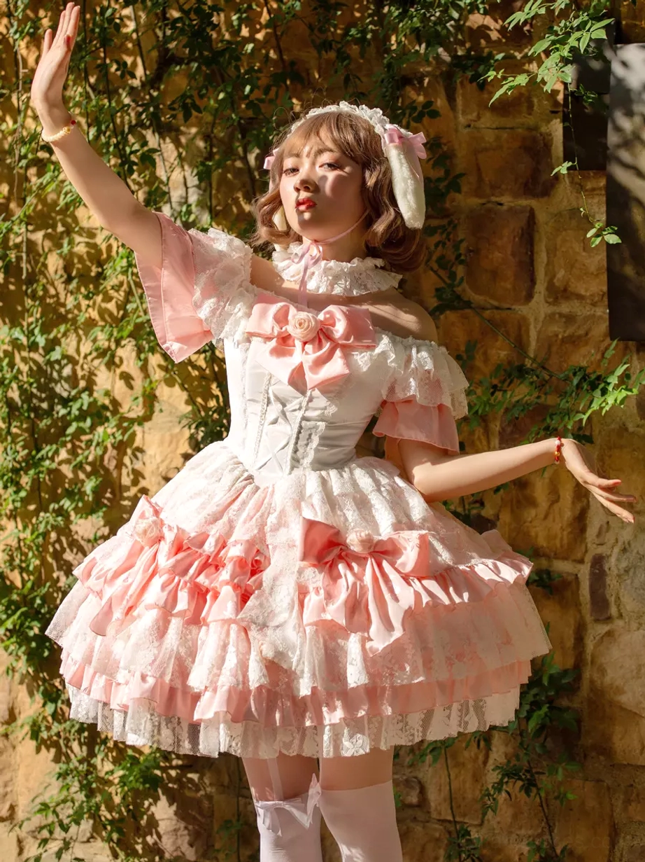 Pink white lolita dress with short ruffle sleeves multiple decorative bows and white thigh-high stockings ivy wall background