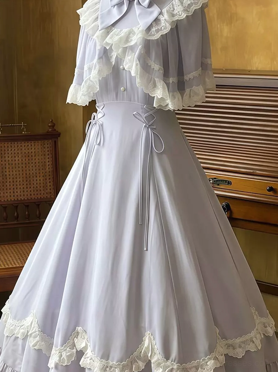 Close-up detail of lower dress section showing precisely scalloped and ruffled lace hem, drawstring waist control feature, and delicate lace craftsmanship from side angle