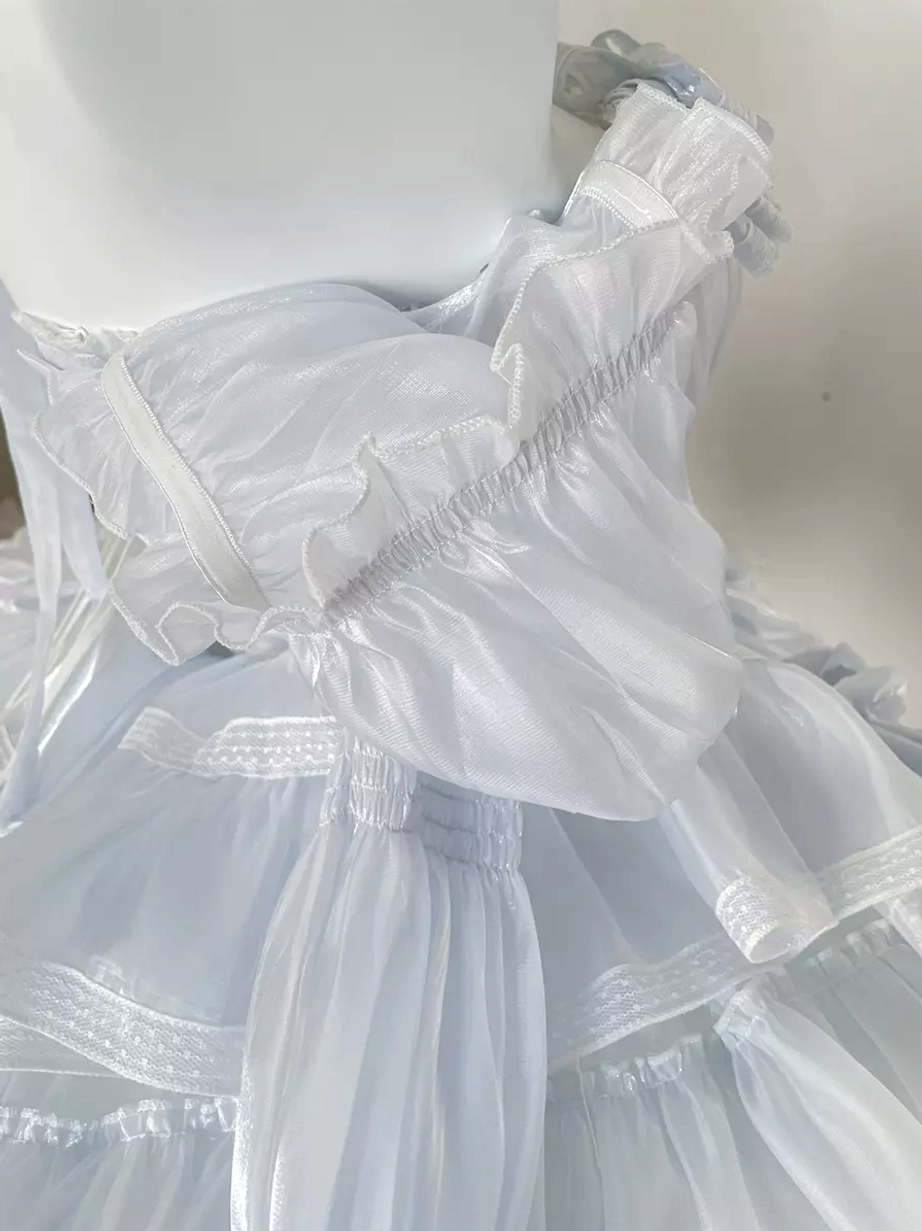 Lolita dress side profile view demonstrating bell-shaped silhouette, tiered ruffle volume, light blue iridescent fabric sheen, and authentic sweet lolita proportions