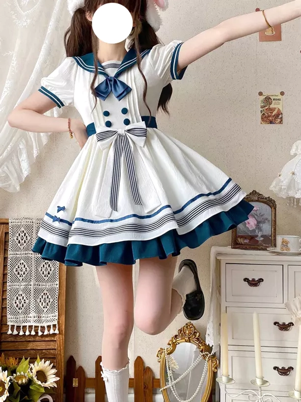 Navy sailor lolita dress side angle view showing a-line ruffled mini skirt striped hem trim and sailor collar details