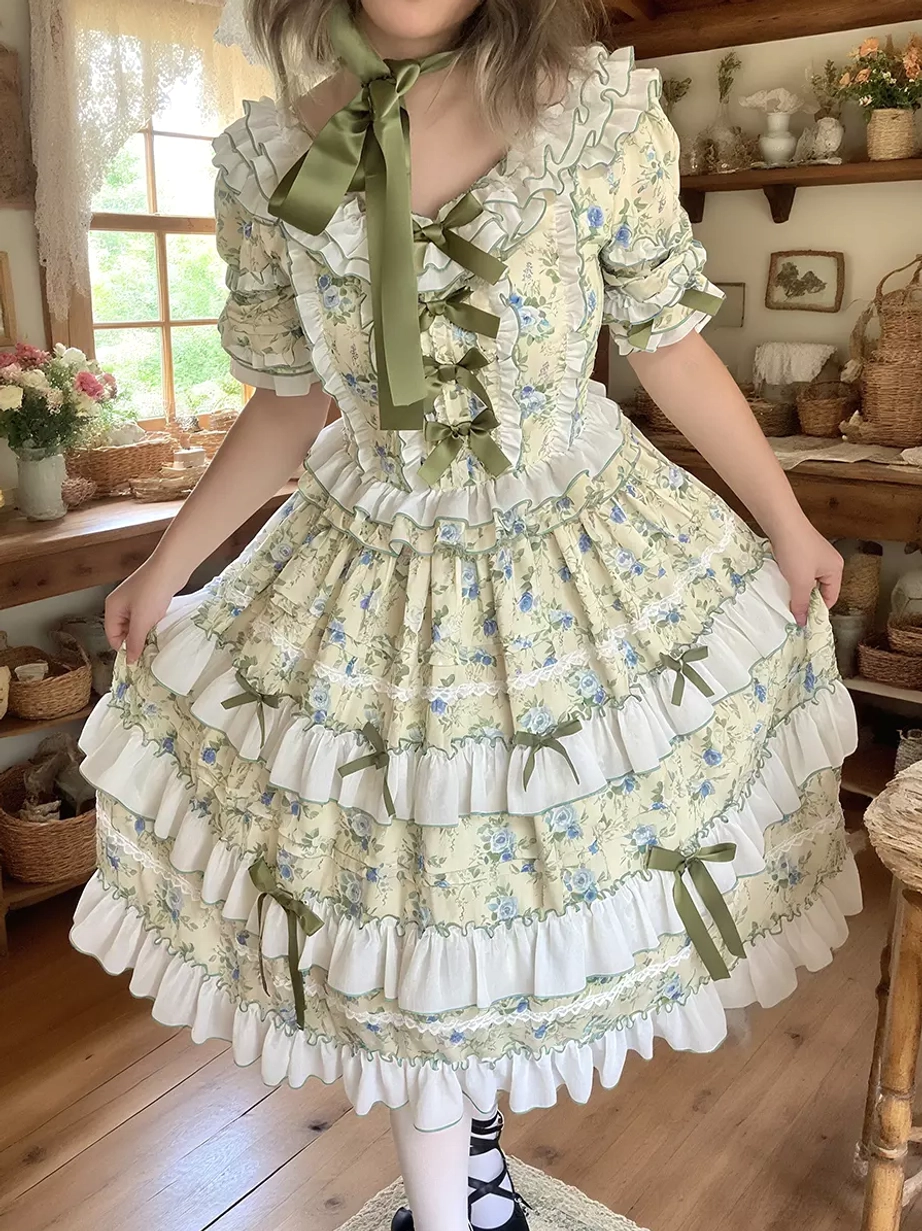 Lolita dress side front view skirt lift green neck ribbon tiered ruffled skirt green bows wooden vintage room