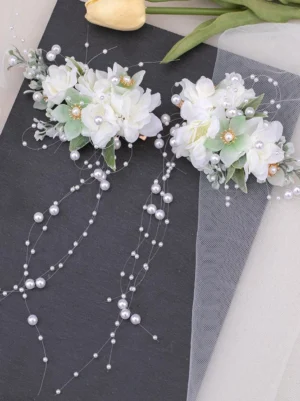 Pair of artificial flower hair clips with pearl tassel chains, visible gold hair fasteners, and delicate flower clusters - flat lay photography perfect for lolita tea party coordinates