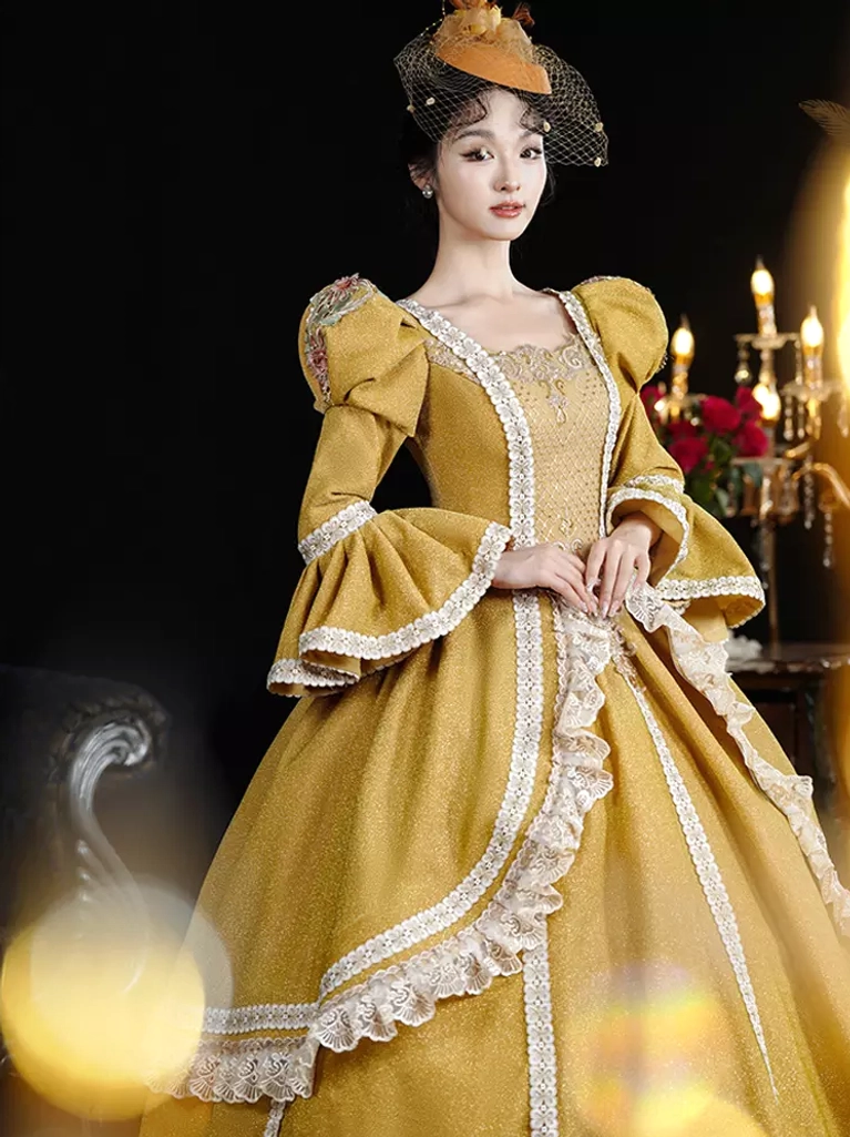 Close-up front detail of mustard yellow lolita dress featuring square neckline with ruffle lace trim, puff bell sleeves, and ornate embellishments in candlelit studio