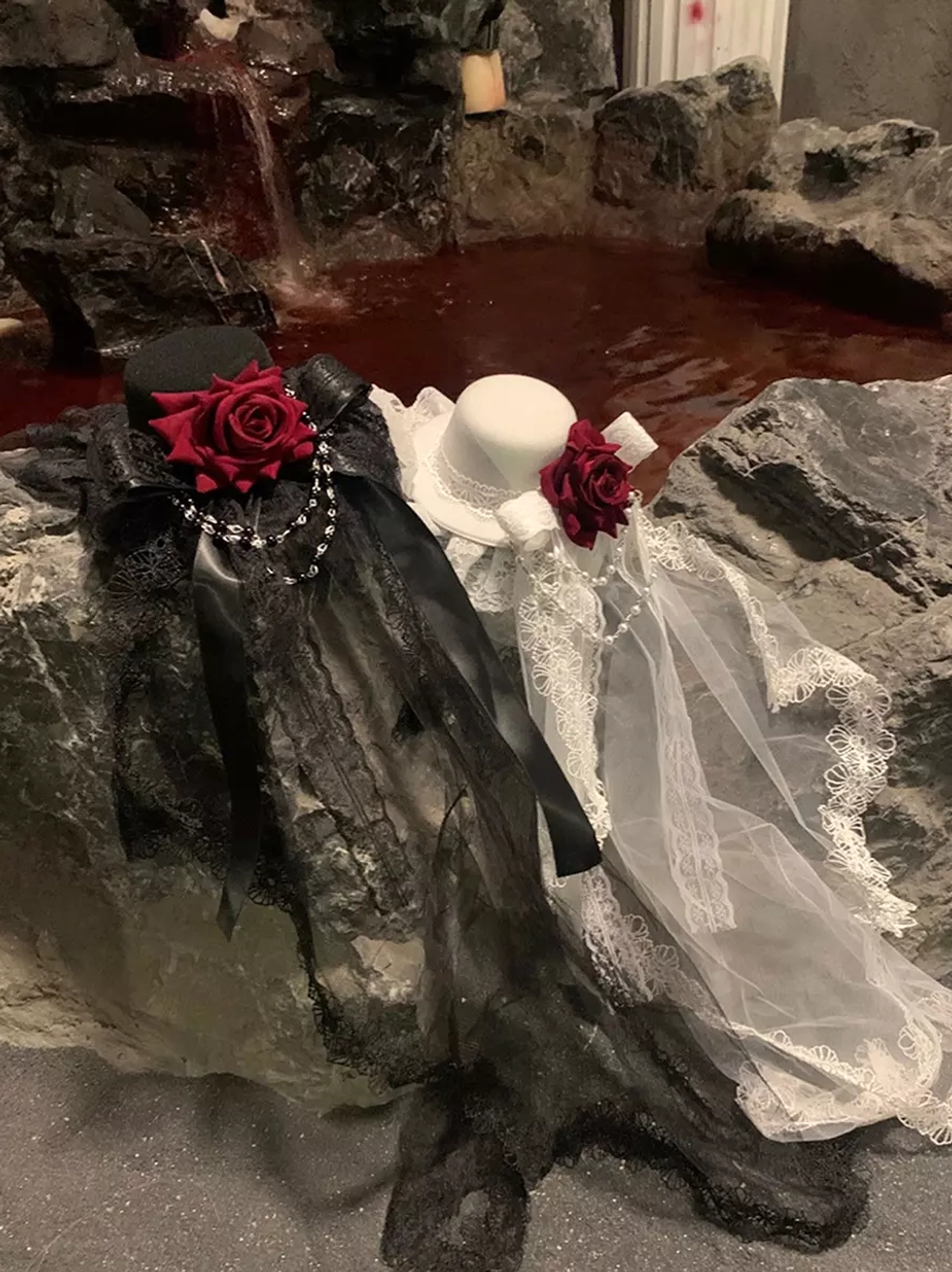 Lolita hair accessory set with matching lace veil and red rose in angled static display against rocky waterfall indoor scene background
