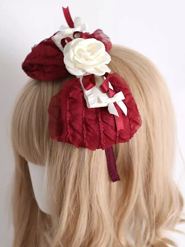 Classic lolita headwear featuring wine red ruffled chiffon bows white roses and ribbon accents back view on mannequin