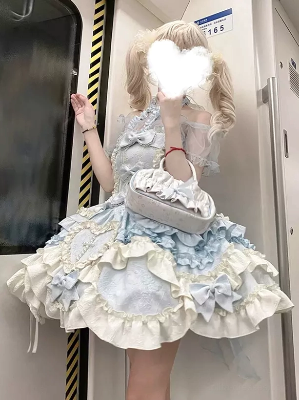 Lolita halter dress back view standing pose ruffled skirt bowknot accents on back blonde model subway scene