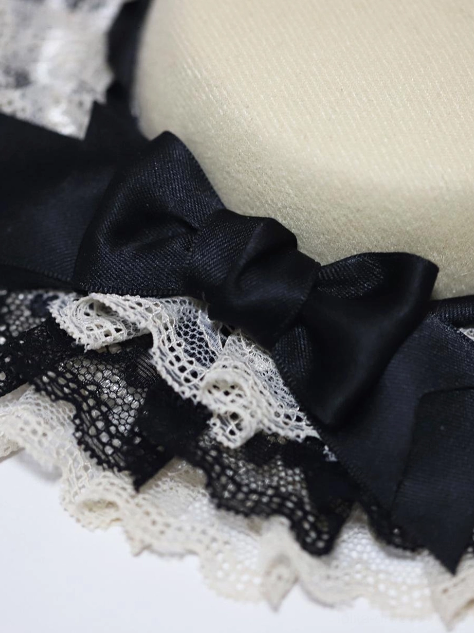Close-up side view detail of Lolita hat showing multi-layer ruffled lace construction, black satin bow embellishment, and textured hat fabric craftsmanship