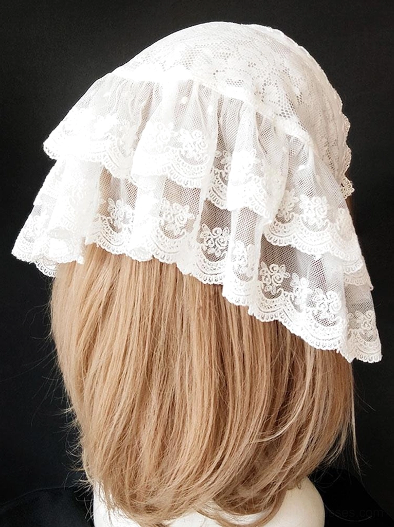 Back view of white lolita lace headdress displaying multi-tiered ruffled lace with floral embroidered trim and structural design