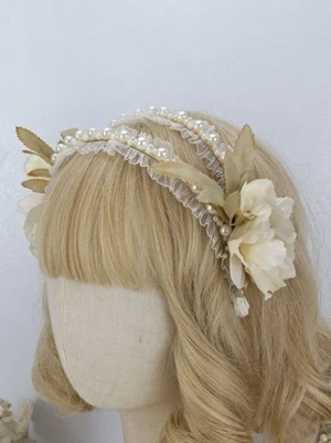 Light beige flowers with double pearl ruffled Lolita headdress and hanging pearl detail, shown from left rear angle on mannequin