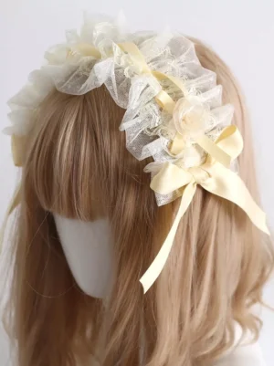 Lolita headdress featuring sheer mesh ruffle detail with beige satin bow and decorative fabric rose, front side view showcasing lace construction