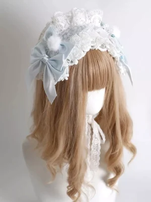 Multi-layer lace lolita headdress front oblique angle showing fluffy pompom and trailing lace strap