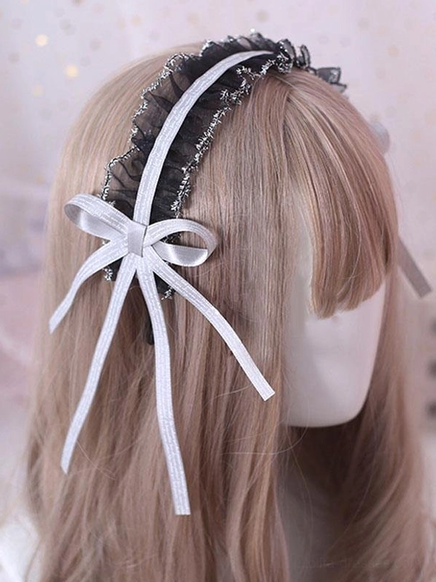 White ribbon lolita headdress with black ruffled lace and silver trim shown from rear view on mannequin head with pure white flowing ribbon tails