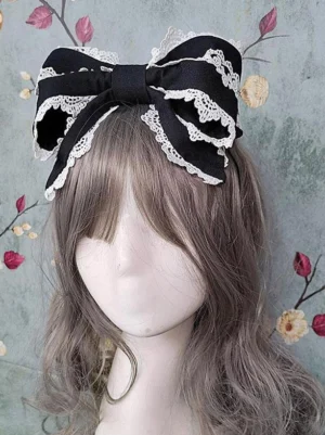 Gothic lolita black-and-white bow headdress with ruffled lace detailing side profile showing intricate embellishment design