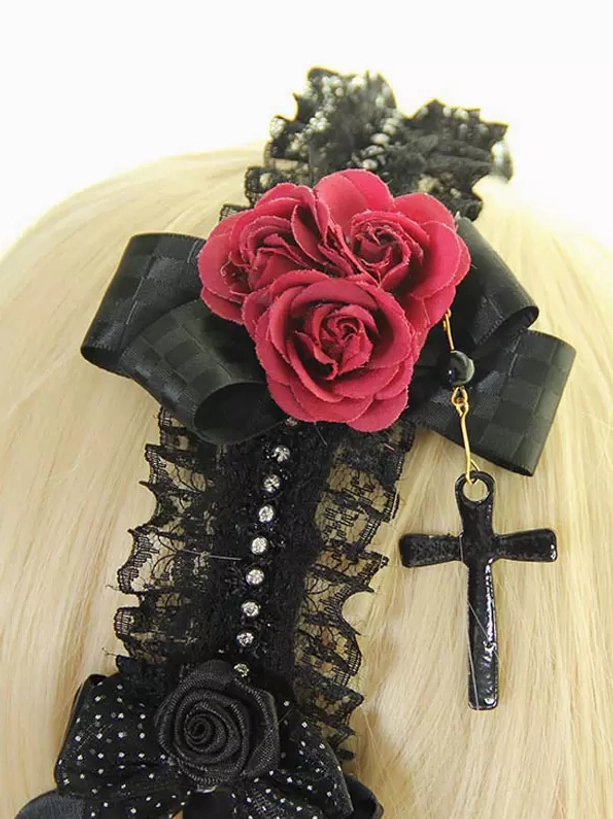 Front view lolita headdress on mannequin head showcasing wine red roses black lace bows small fabric rose accents dangling cross pendant gothic aesthetic