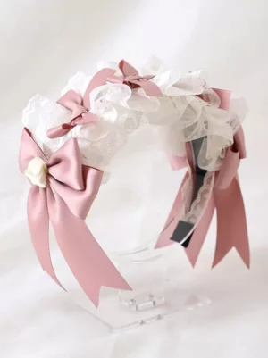 Lolita headdress side display view on acrylic stand showing black headband base mesh lace pink bow rose decoration