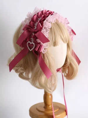Lolita headdress left side view showing layered satin bows and heart rhinestone pendant detail