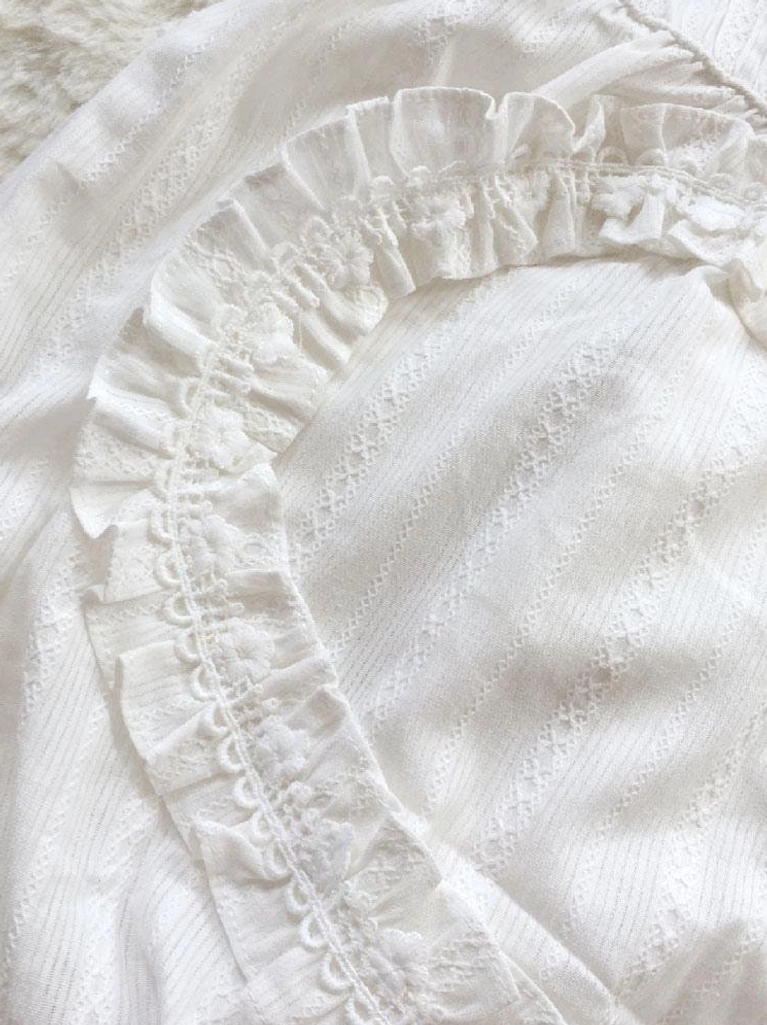 Jacquard lolita fabric close-up showing scalloped lace ruffle and subtle striped woven texture