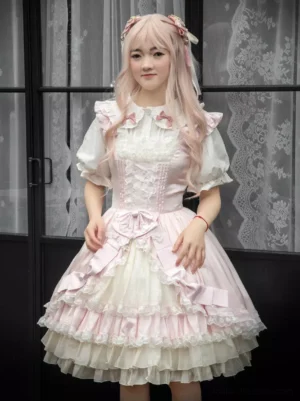 Enchanted sweet lolita JSK dress full body front pose showing peter pan collar and layered ruffled skirt design in pink white