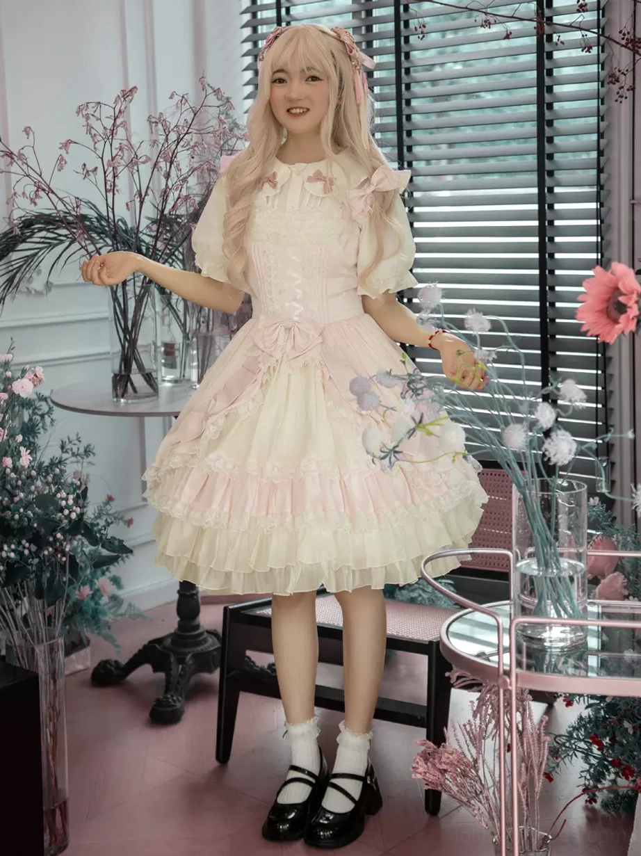 Sweet lolita dress dynamic front pose holding floral props indoor flower shop scene pink wig short puff sleeves detail