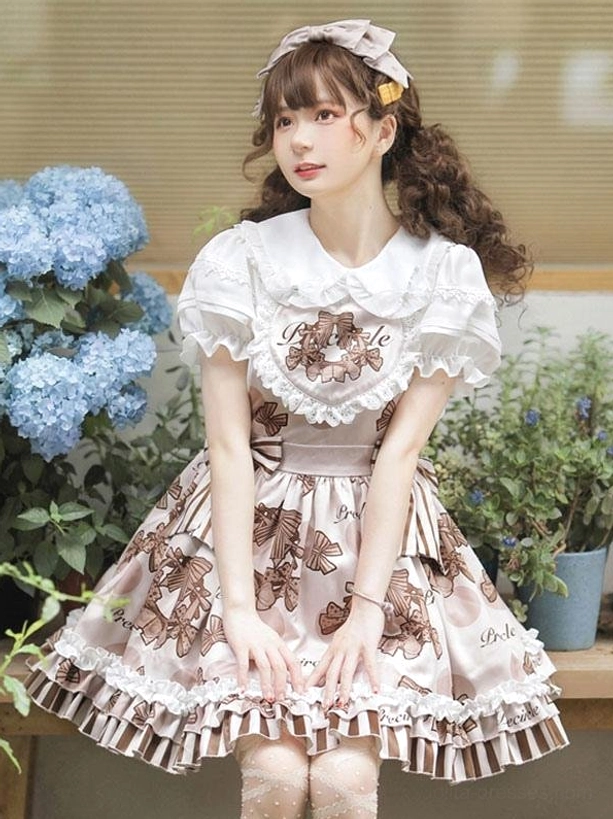 Full front lolita jumper skirt outfit with matching hair bow, sheer stockings, striped waist sash, displayed with blue hydrangea potted plants