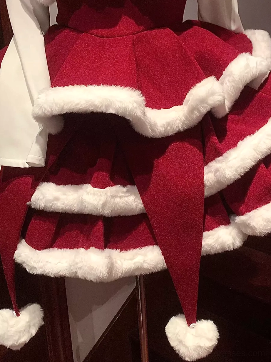 Multi-layered fluffy trim and pointed pom-pom hem of red and white sweet lolita jumper skirt side close-up detail view
