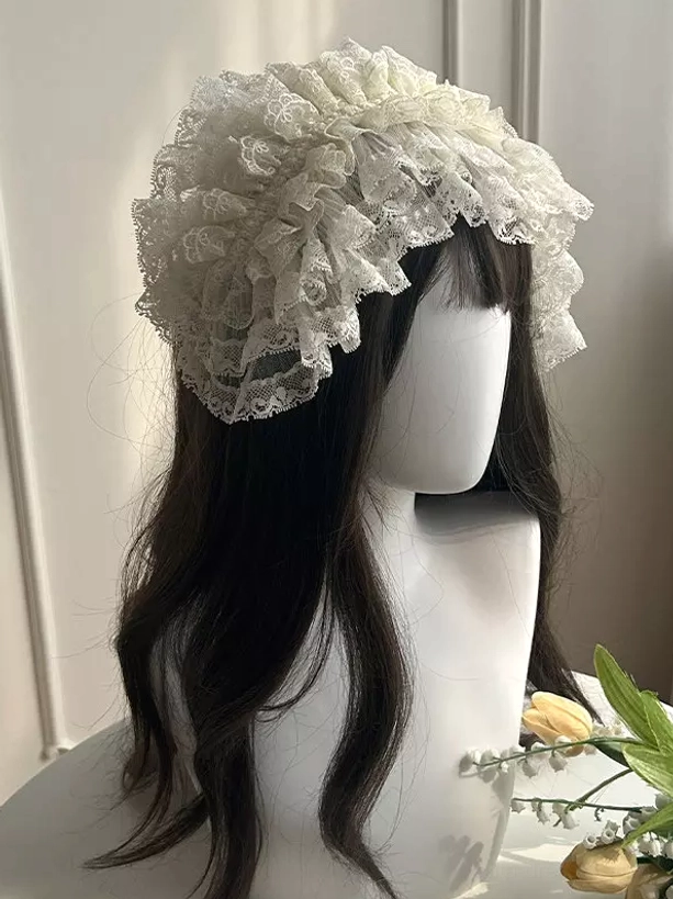 Oversized ruffled lace bonnet headdress for lolita outfit mannequin with long dark wig vintage bridal style floral decoration close-up view