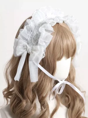Lolita headdress three-quarter left side view displaying layered embroidered lace panels, generous organza bow, ruffled edges and decorative trim details, worn on mannequin demonstrating how lolita headband frames face elegantly