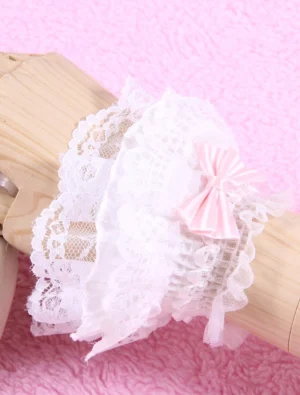 lolita lace wrist cuff close-up side view showing scalloped white lace trim and pink fabric bow accent
