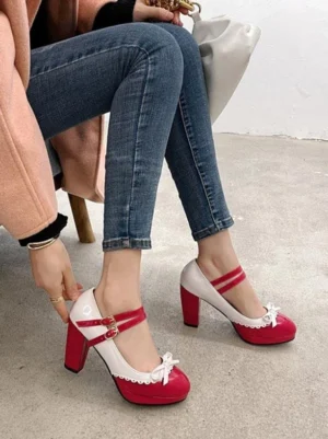 Seated side profile of Lolita Mary Jane high heels in red and white with single ankle strap, buckle closure, and front bow embellishment on model