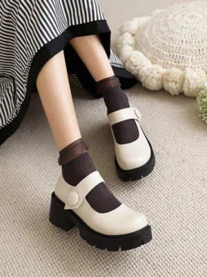 Academic lolita mary jane platform pumps in ecru white with chunky black heel, top-down side angle showing adjustable strap buckle and round toe silhouette