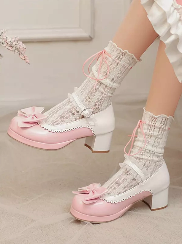 Side profile of pastel pink and white Lolita pumps showing chunky block heel, Mary Jane buckle strap, and scalloped edge detailing with frilly lace ribbon socks