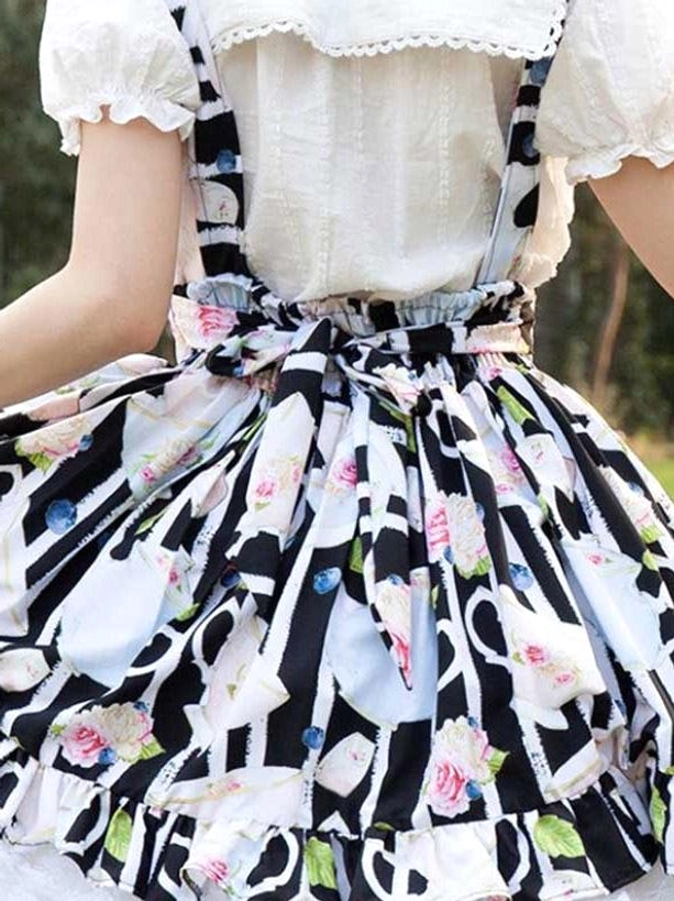Back detail of lolita outfit showing coordinating waist bow, peter pan collar blouse, and printed fabric texture
