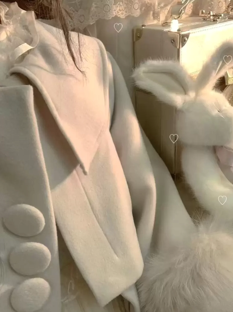 Close-up detail shot of ecru white sweet lolita overcoat showing round fabric buttons construction, large doll collar lapels, fluffy white fur trim detail, product-focused photography without model for garment construction inspection