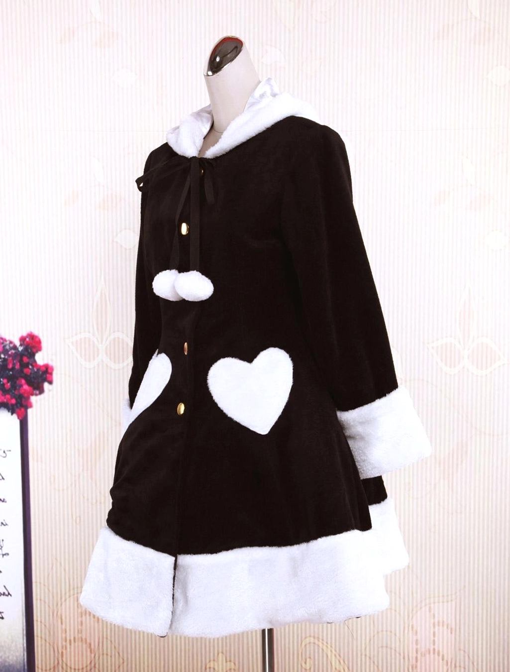 Side mannequin view of black lolita overcoat showing consistent white fuzzy trim details, A-line construction, and sleeve length