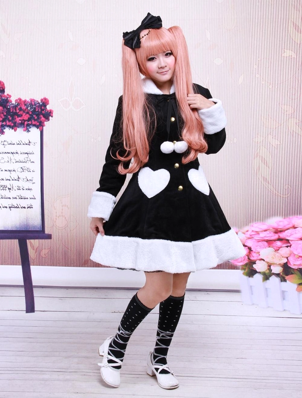 Three-quarter side view of black wool lolita overcoat displaying fitted A-line silhouette and ruffled fuzzy hem detail