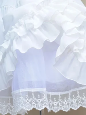 Close-up detail of Lolita petticoat sheer mesh lining embroidered lace hem satin frills ruffled construction side overhead view