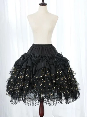 Close-up detail of black Lolita petticoat displaying gold star printed mesh, decorative ruffled bows, and handcrafted tassel lace hem